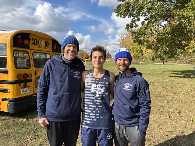 After a strong performance, Henry Gamson stands with Head Coach Steve Buti (left) and Assistant Coach Mike Czajkowsky (right).