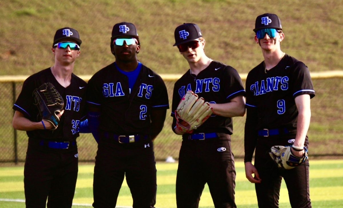 Paxton Feeder, Shamar Wilson, Cooper Kasdin, and Simon Rose posing together during warm ups.