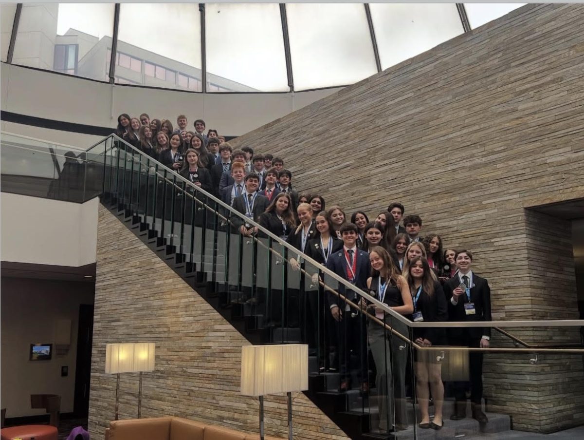 The Highland Park DECA Team lines up for a team photo at State in Rosemont, Illinois.